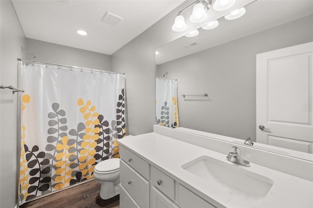 832 Kinney Cir NE, Bondurant, IA 50035 - bathroom with vanity, wood finished floors, a shower with shower curtain, and recessed lighting
