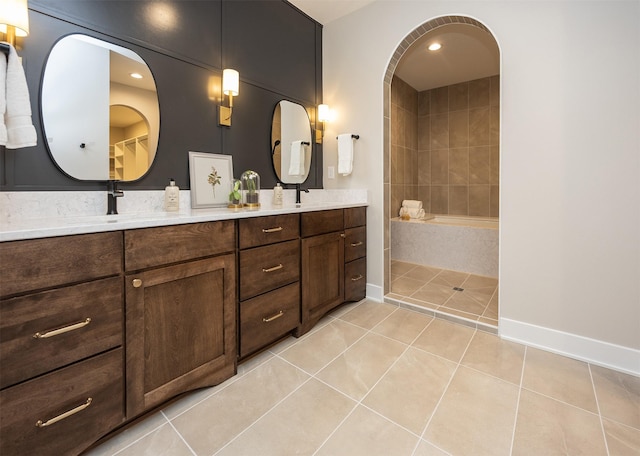 1128 NW 29th Ct, Grimes, IA 50111 - bathroom featuring tile patterned floors, double vanity, and tiled shower