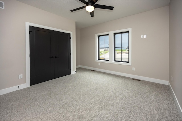 1128 NW 29th Ct, Grimes, IA 50111 - unfurnished bedroom with carpet, ceiling fan, and a closet