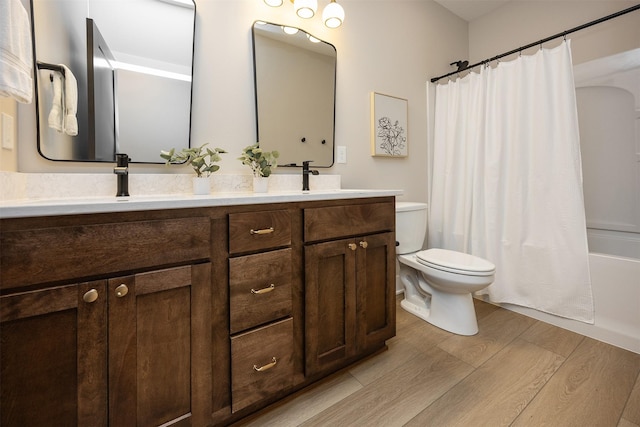 1128 NW 29th Ct, Grimes, IA 50111 - bathroom featuring wood finished floors, double vanity, and shower / tub combo with curtain