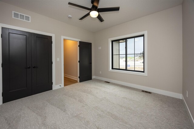 1128 NW 29th Ct, Grimes, IA 50111 - unfurnished bedroom with carpet floors, a closet, and ceiling fan