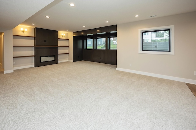 1128 NW 29th Ct, Grimes, IA 50111 - unfurnished living room featuring light carpet, a large fireplace, and recessed lighting