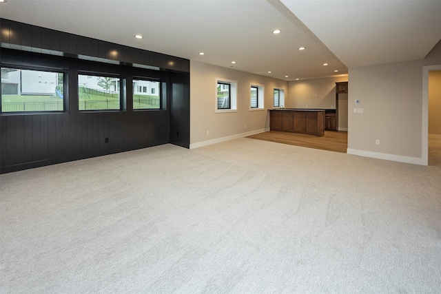 1128 NW 29th Ct, Grimes, IA 50111 - unfurnished living room featuring light colored carpet and recessed lighting