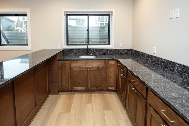 1128 NW 29th Ct, Grimes, IA 50111 - kitchen with dark stone counters and light wood-style flooring