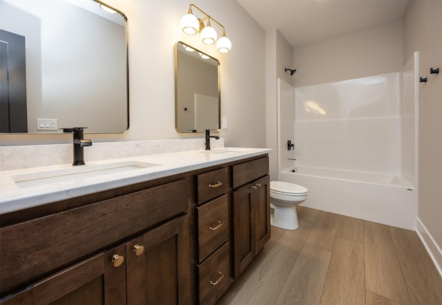 1128 NW 29th Ct, Grimes, IA 50111 - bathroom with wood finished floors, double vanity, and bathtub / shower combination