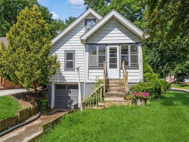 2928 34th St, Des Moines, IA 50310 - view of front of house with an attached garage, a front yard, a sunroom, entry steps, and driveway