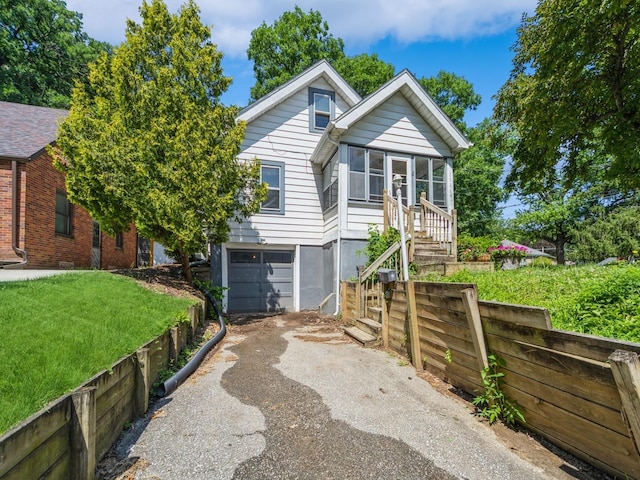 2928 34th St, Des Moines, IA 50310 - view of front of house featuring asphalt driveway and an attached garage