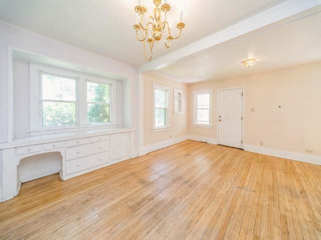 2928 34th St, Des Moines, IA 50310 - foyer with light wood-style flooring, a chandelier, and beamed ceiling