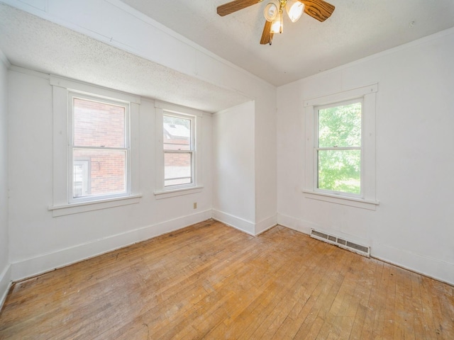 2928 34th St, Des Moines, IA 50310 - empty room featuring light wood-type flooring, ceiling fan, and a textured ceiling