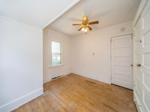 2928 34th St, Des Moines, IA 50310 - unfurnished room featuring a ceiling fan, light wood finished floors, and a textured ceiling