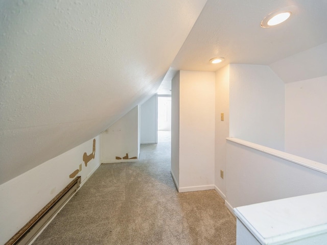 2928 34th St, Des Moines, IA 50310 - bonus room featuring lofted ceiling, carpet, and a textured ceiling