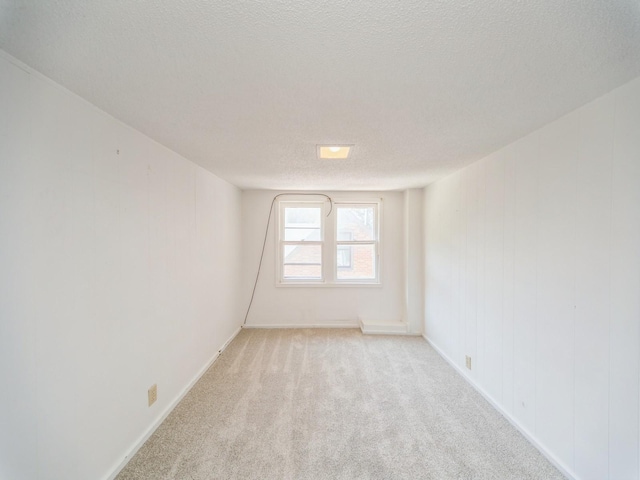 2928 34th St, Des Moines, IA 50310 - spare room featuring light carpet and a textured ceiling