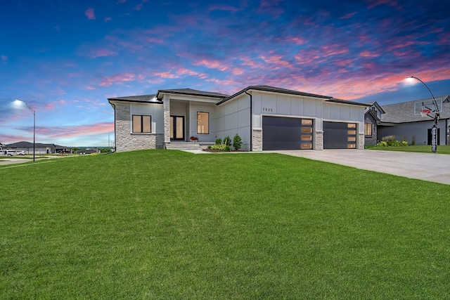 1305 NW 28th St, Grimes, IA 50111 - contemporary home featuring an attached garage, stone siding, a front yard, board and batten siding, and driveway