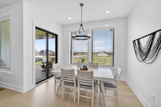 1305 NW 28th St, Grimes, IA 50111 - dining area featuring a chandelier, light wood-style flooring, and recessed lighting