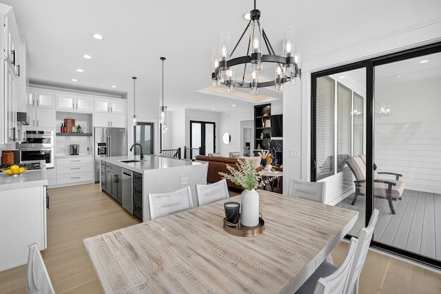 1305 NW 28th St, Grimes, IA 50111 - dining space with a chandelier, light wood-type flooring, and recessed lighting