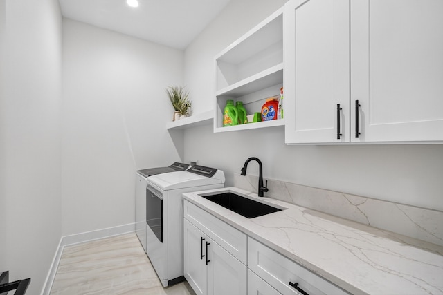 1305 NW 28th St, Grimes, IA 50111 - laundry area with independent washer and dryer, cabinet space, light wood finished floors, and recessed lighting