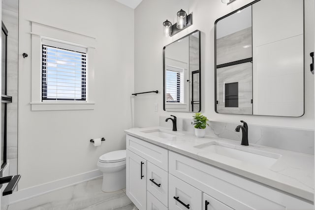 1305 NW 28th St, Grimes, IA 50111 - bathroom featuring marble finish floors, double vanity, and a shower with shower door