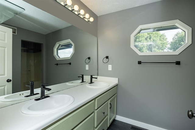 3170 E Kenyon Ave, Des Moines, IA 50320 - bathroom featuring double vanity and baseboards