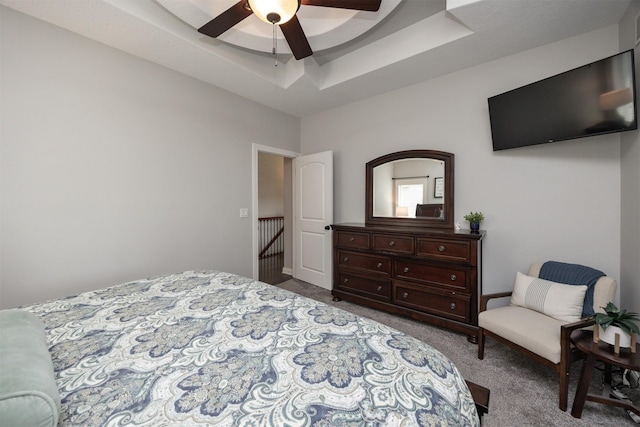 9824 Dunmore Cir, Johnston, IA 50131 - bedroom with carpet floors, a tray ceiling, and ceiling fan