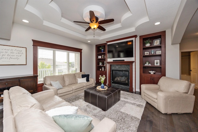 9824 Dunmore Cir, Johnston, IA 50131 - living area with dark wood-style floors, ceiling fan, a raised ceiling, a fireplace, and recessed lighting