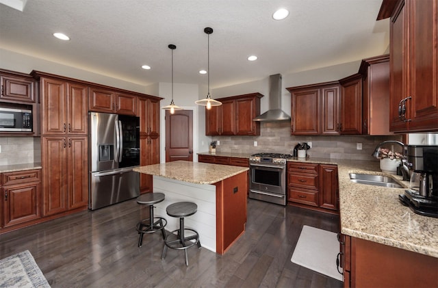 9824 Dunmore Cir, Johnston, IA 50131 - kitchen featuring appliances with stainless steel finishes, wall chimney range hood, a center island, tasteful backsplash, and light stone counters