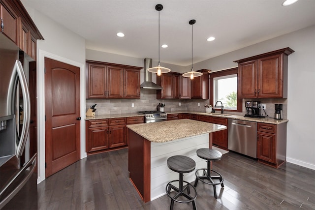 9824 Dunmore Cir, Johnston, IA 50131 - kitchen featuring appliances with stainless steel finishes, wall chimney exhaust hood, dark wood-style flooring, tasteful backsplash, and recessed lighting