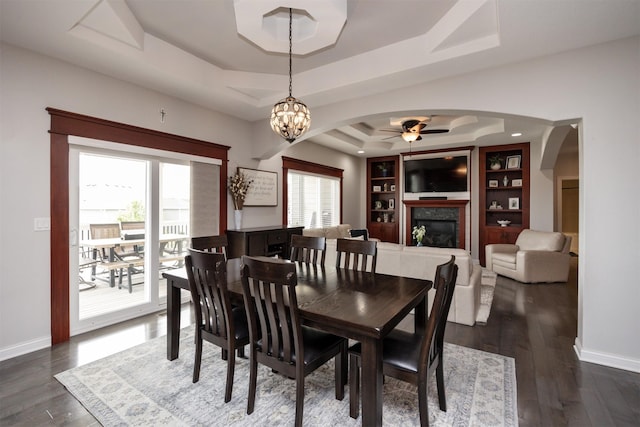 9824 Dunmore Cir, Johnston, IA 50131 - dining space with a tray ceiling, ceiling fan, arched walkways, and healthy amount of natural light