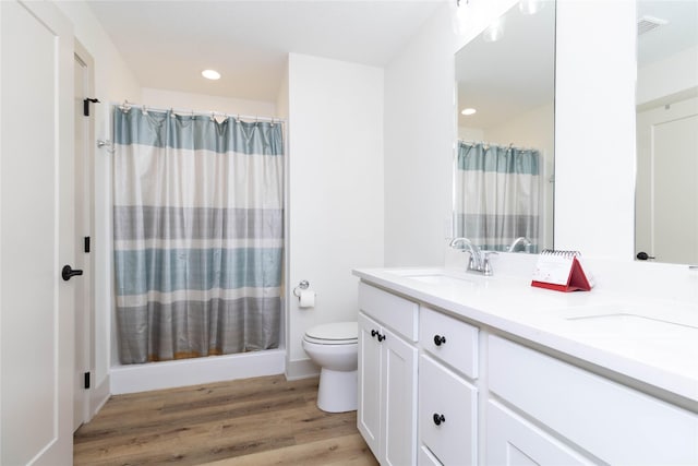 720 Spruce St NW, Bondurant, IA 50035 - full bath with double vanity, wood finished floors, a shower with shower curtain, and recessed lighting