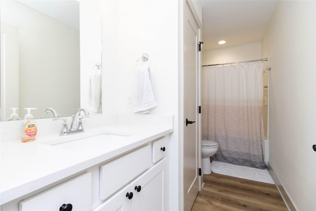 720 Spruce St NW, Bondurant, IA 50035 - bathroom featuring vanity, wood finished floors, shower / bath combo, and recessed lighting
