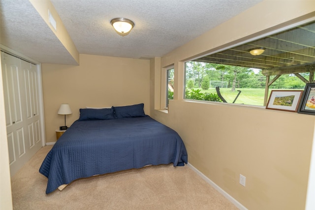 2726 SE 11th St, West Des Moines, IA 50265 - carpeted bedroom featuring a textured ceiling and a closet