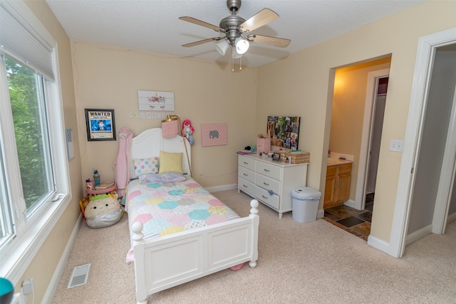2726 SE 11th St, West Des Moines, IA 50265 - bedroom with light colored carpet, ensuite bathroom, and a ceiling fan