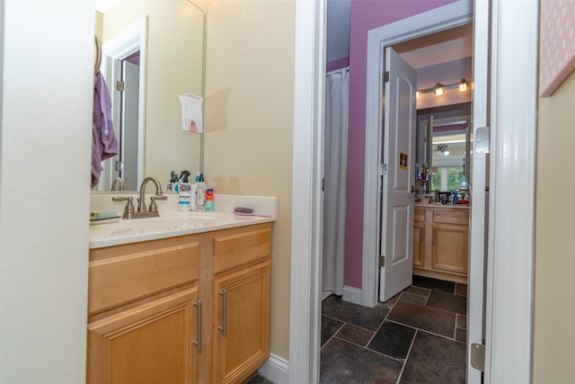 2726 SE 11th St, West Des Moines, IA 50265 - bathroom with stone tile floors and vanity