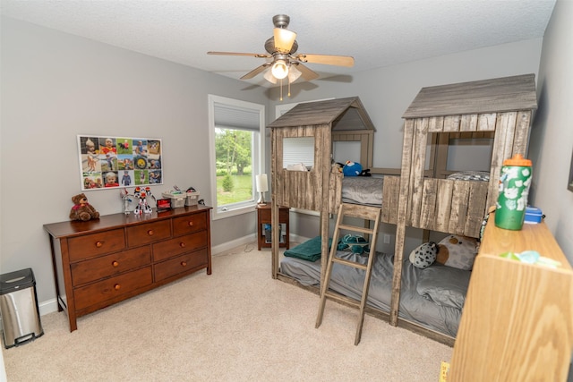 2726 SE 11th St, West Des Moines, IA 50265 - bedroom featuring carpet flooring, a textured ceiling, and a ceiling fan