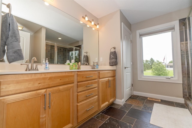 2726 SE 11th St, West Des Moines, IA 50265 - full bathroom with double vanity, a stall shower, and stone tile floors