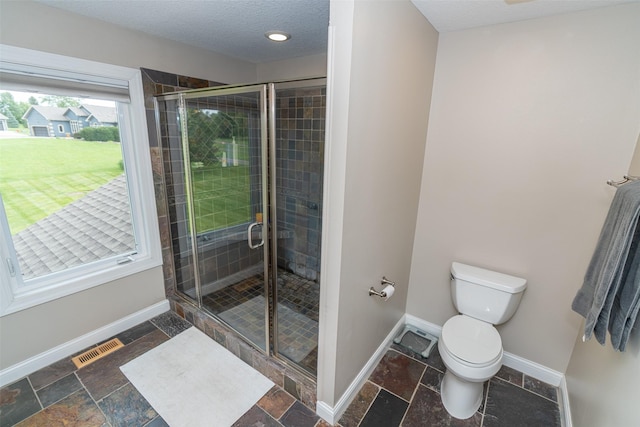 2726 SE 11th St, West Des Moines, IA 50265 - full bathroom featuring a stall shower, stone tile floors, and a textured ceiling