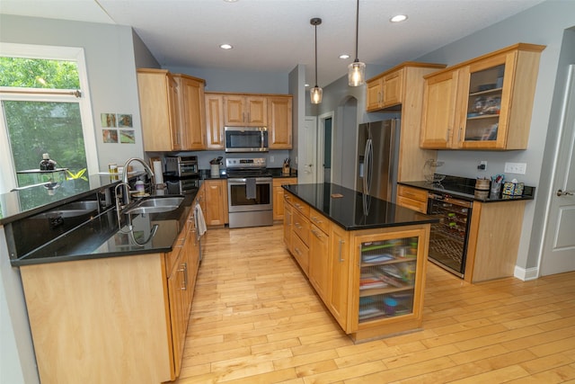 2726 SE 11th St, West Des Moines, IA 50265 - kitchen with appliances with stainless steel finishes, beverage cooler, light wood-style floors, recessed lighting, and a center island