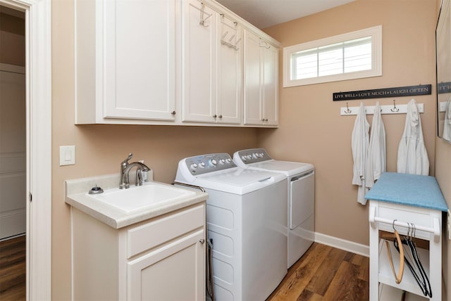 17475 Baxter Dr, Clive, IA 50325 - washroom with washer and clothes dryer, cabinet space, and dark wood finished floors