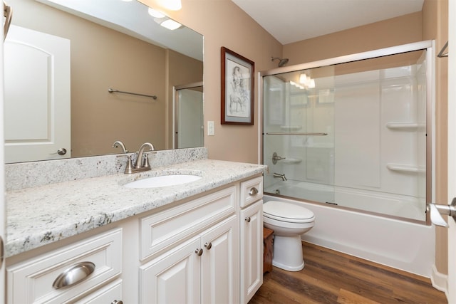 17475 Baxter Dr, Clive, IA 50325 - full bathroom featuring vanity, wood finished floors, and bath / shower combo with glass door