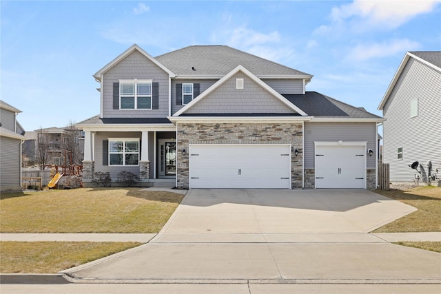 270 NE Prairie Wolf Dr, Waukee, IA 50263 - craftsman house featuring an attached garage, driveway, a front lawn, and stone siding