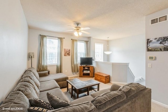 4528 NE Mcdougal Ln, Ankeny, IA 50021 - living area with light carpet, ceiling fan, and a textured ceiling