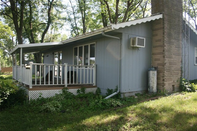 13018 137th Ave, Plano, IA 52581 - view of property exterior with a deck, a chimney, and a wall unit AC
