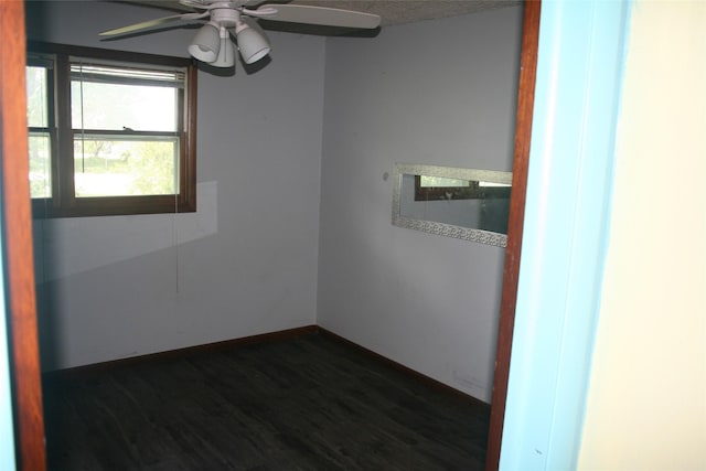13018 137th Ave, Plano, IA 52581 - empty room featuring a ceiling fan and dark wood-style floors