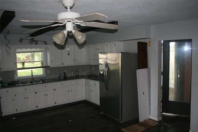 13018 137th Ave, Plano, IA 52581 - kitchen featuring stainless steel fridge, backsplash, white cabinets, dark wood-type flooring, and a textured ceiling