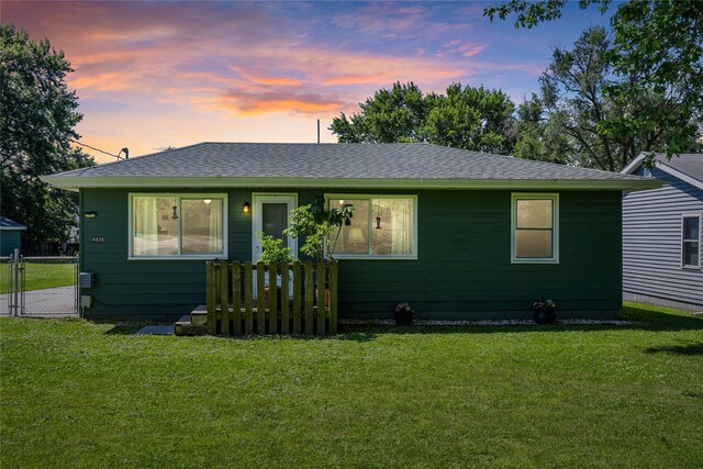 4935 NE 39th Ave, Des Moines, IA 50317 - view of front facade with a front lawn, roof with shingles, and a gate
