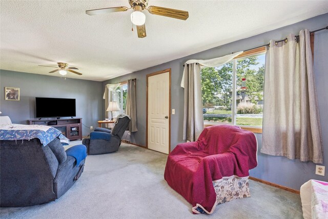 4935 NE 39th Ave, Des Moines, IA 50317 - carpeted living room featuring ceiling fan, plenty of natural light, and a textured ceiling