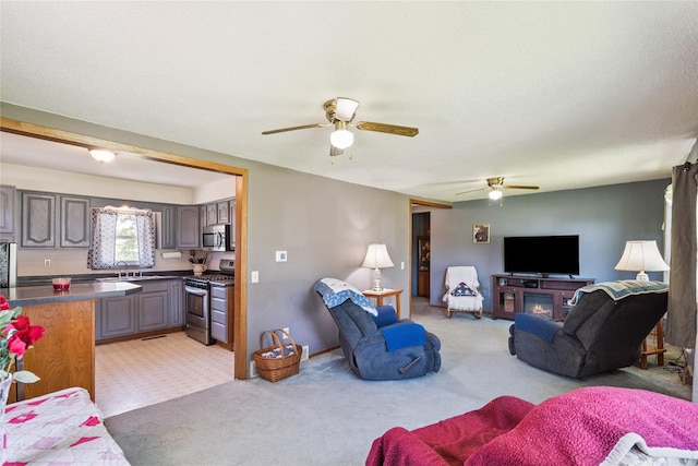 4935 NE 39th Ave, Des Moines, IA 50317 - living area featuring ceiling fan and light carpet