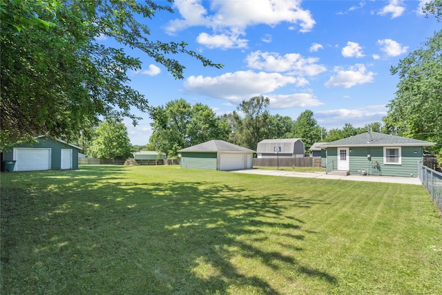 4935 NE 39th Ave, Des Moines, IA 50317 - fenced backyard with a detached garage and an outdoor structure