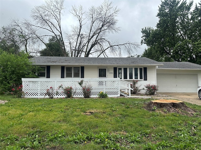 1205 S 4th St, Marshalltown, IA 50158 - ranch-style house featuring a front yard, concrete driveway, and an attached garage