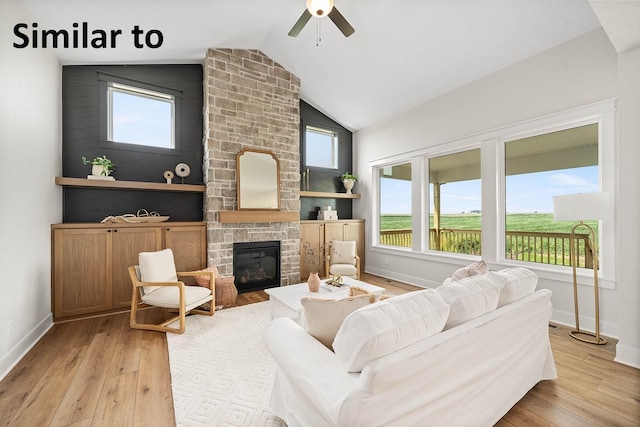 1156 NW 31st St, Grimes, IA 50111 - living room featuring wood finished floors, lofted ceiling, a stone fireplace, and a ceiling fan