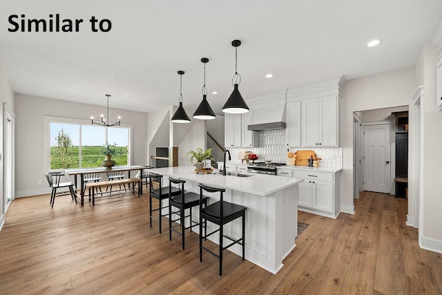 1156 NW 31st St, Grimes, IA 50111 - kitchen with tasteful backsplash, stainless steel gas range oven, light countertops, a kitchen bar, and white cabinetry